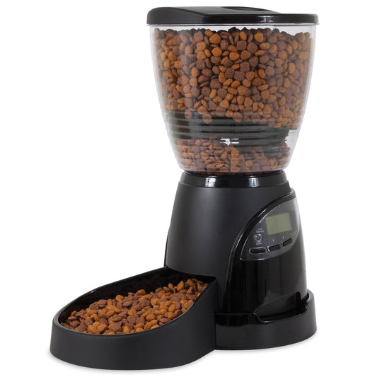 Aspen Pet Lebistro Programmable Food Dispenser features a transparent hopper filled with brown kibble, portion control, and an LCD screen with control buttons on its black base. It dispenses kibble into a front-attached bowl for convenient feeding.